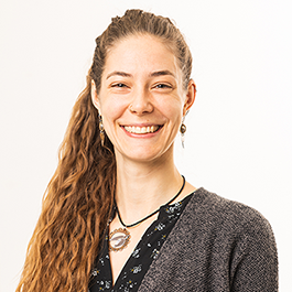 headshot of Anna Irish Burnett, a smiling woman with long curly light brown hair